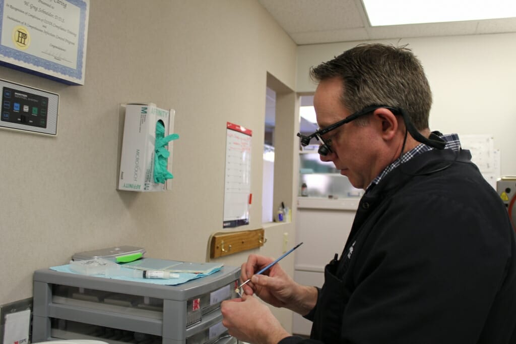 Dr. Schneider Working on Dental Implant
