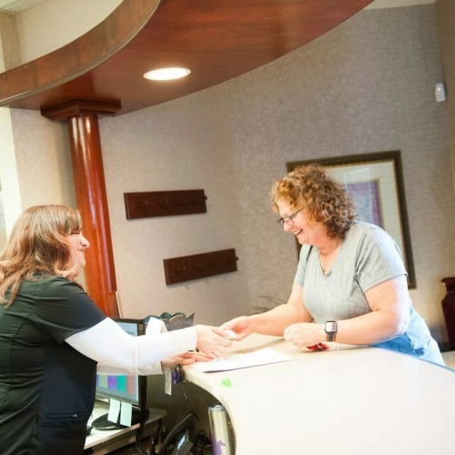 Schneider family dental team working with patient