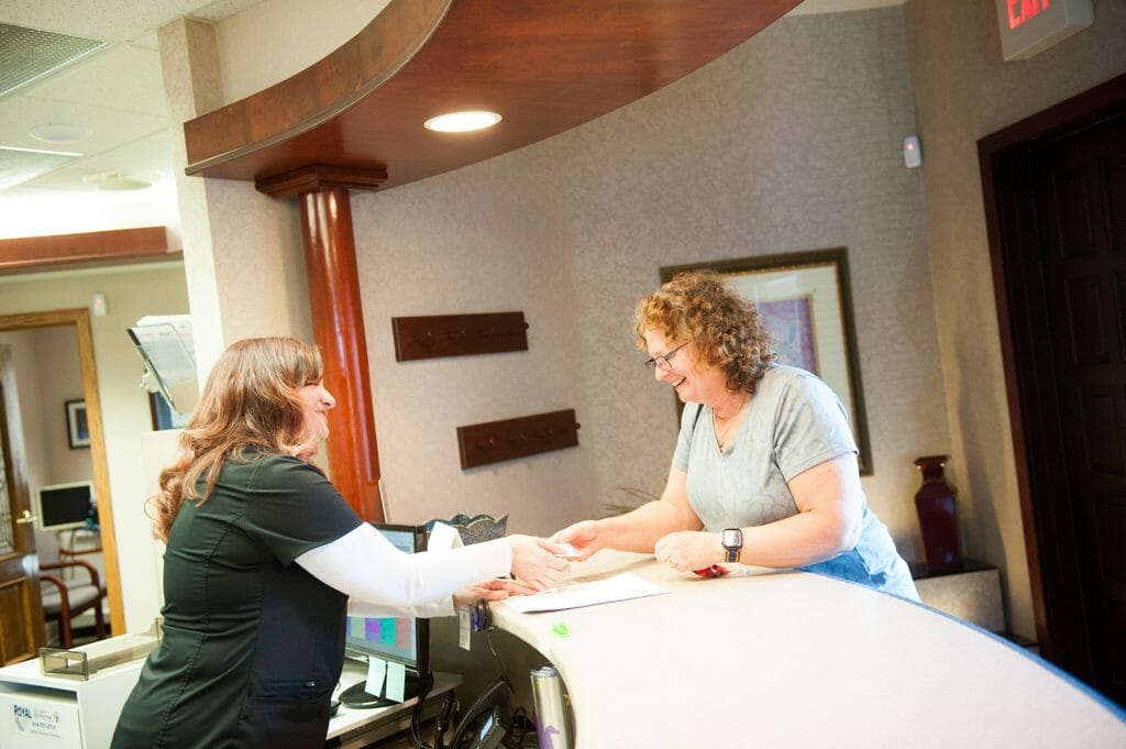 Schneider family dental team working with patient